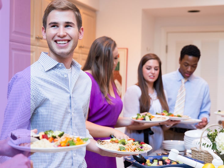 Students, faculty and alumni enjoy a Dinner for Twelve Strangers get-together.