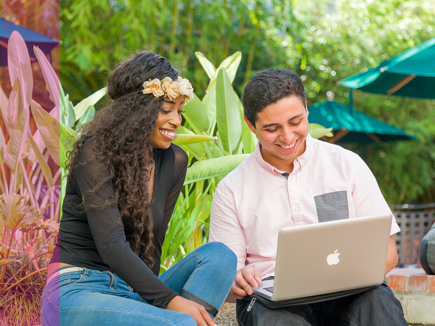 Two students work together on an online application.