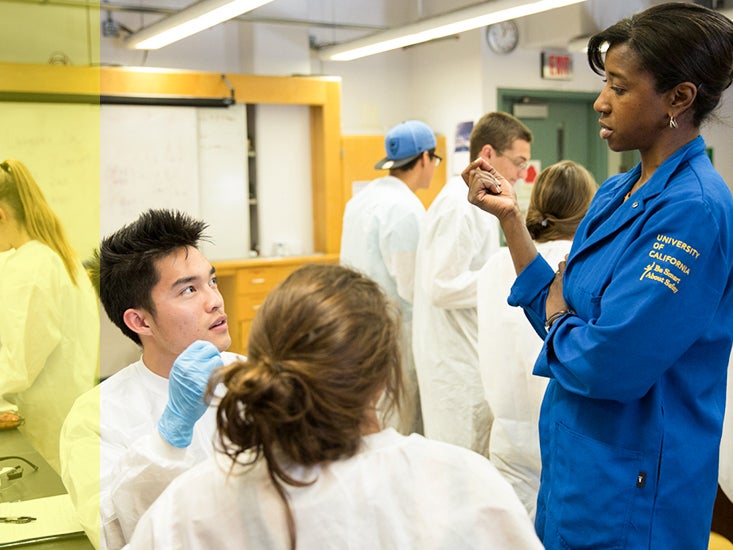 Professor Jennifer Jay works with a student in her lab.
