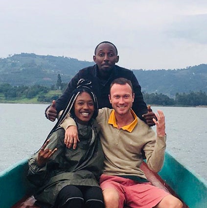 Kelli Hamilton and two friends pose in a boat on the water in South Africa.