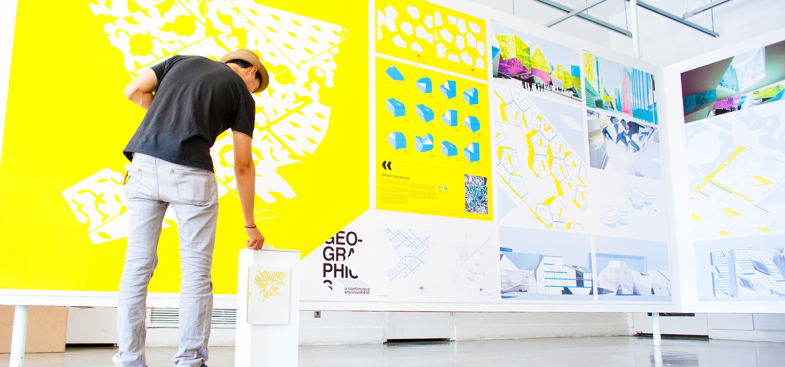 A student checks out his end-of-year art exhibit on campus.