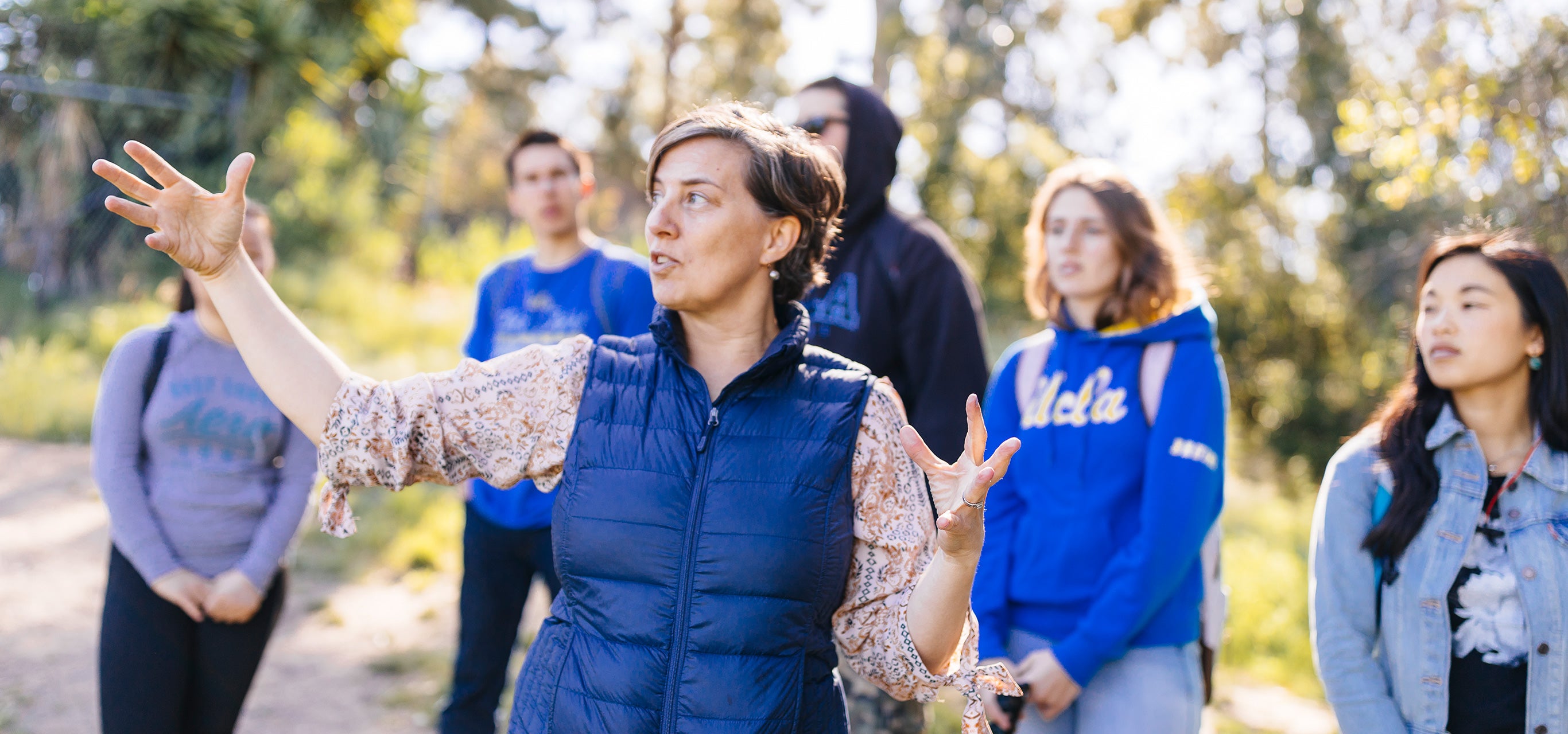 A professor teaches a class outdoors.