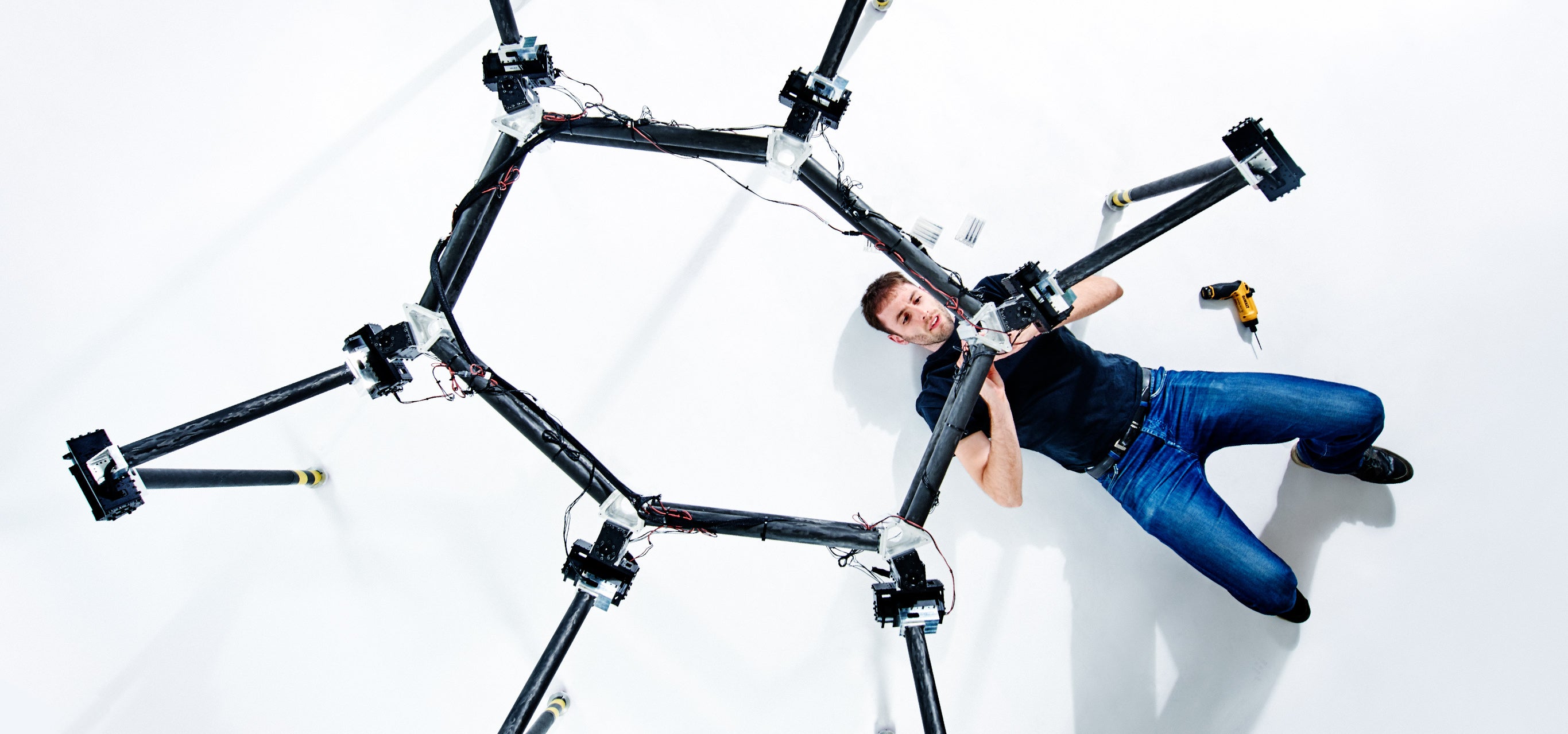 A student works on a robotics project in a lab.