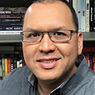 A headshot of Professor Keith L. Camacho