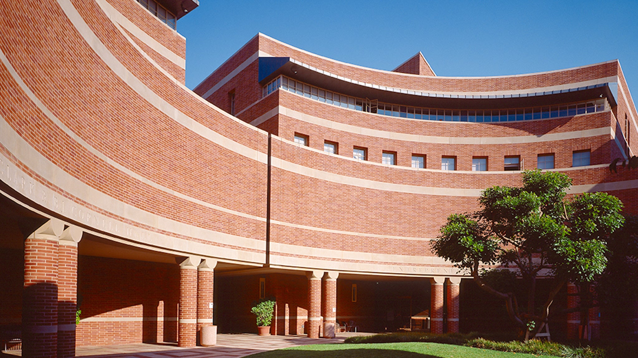 Students walk down the front steps of the UCLA Anderson School of Management.