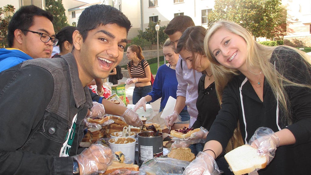 Volunteers with Swipe Out Hunger prepare sandwiches for food-insecure students.