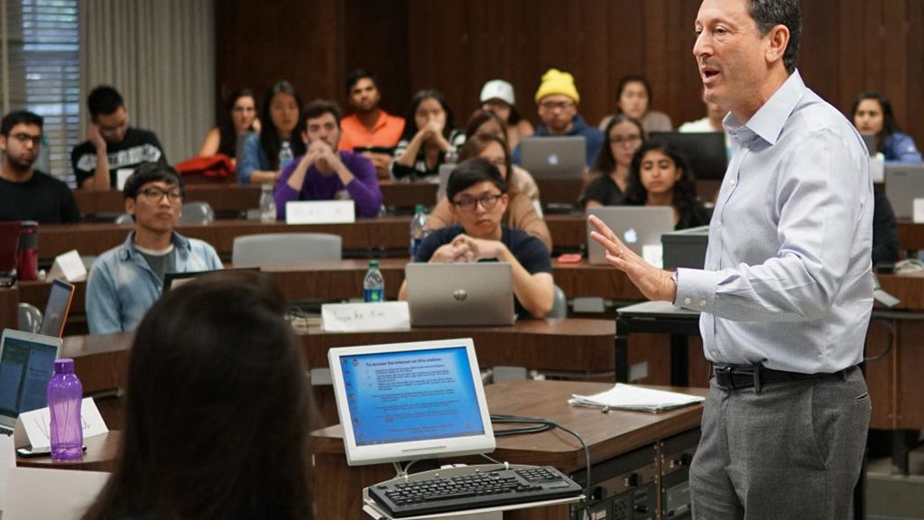 Students listen and take notes on their laptops as Adjunct Professor Terry Kramer lectures.