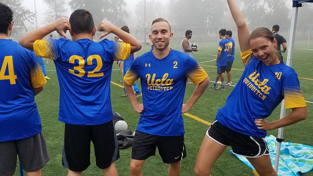 Quidditch teammates stretch and have fun together.