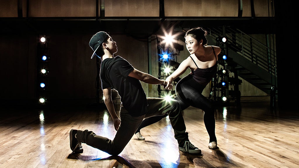 Two dance students perform a dance that combines ballet with modern dance.