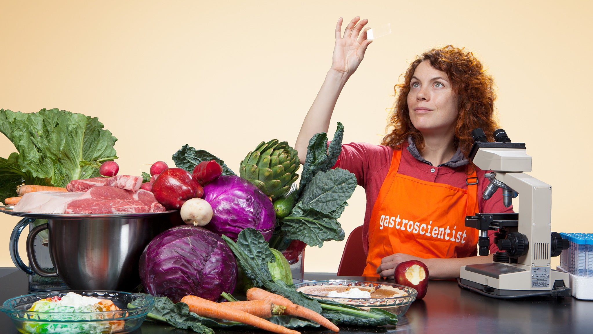 Professor of Integrative Biology and Physiology Amy Rowat poses with a tableful of food.