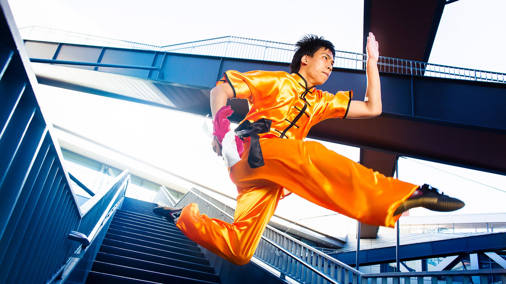 A Wushu team member demonstrates a jumping move.