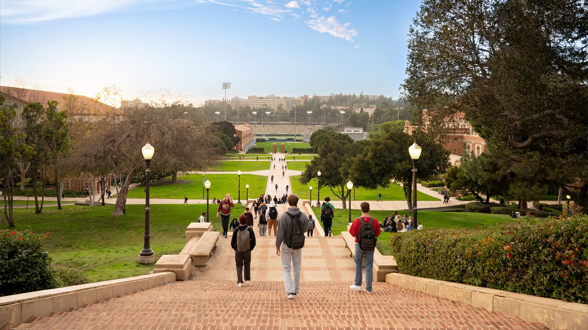 Students head down Janss Steps and enjoy the sun on Wilson Plaza.