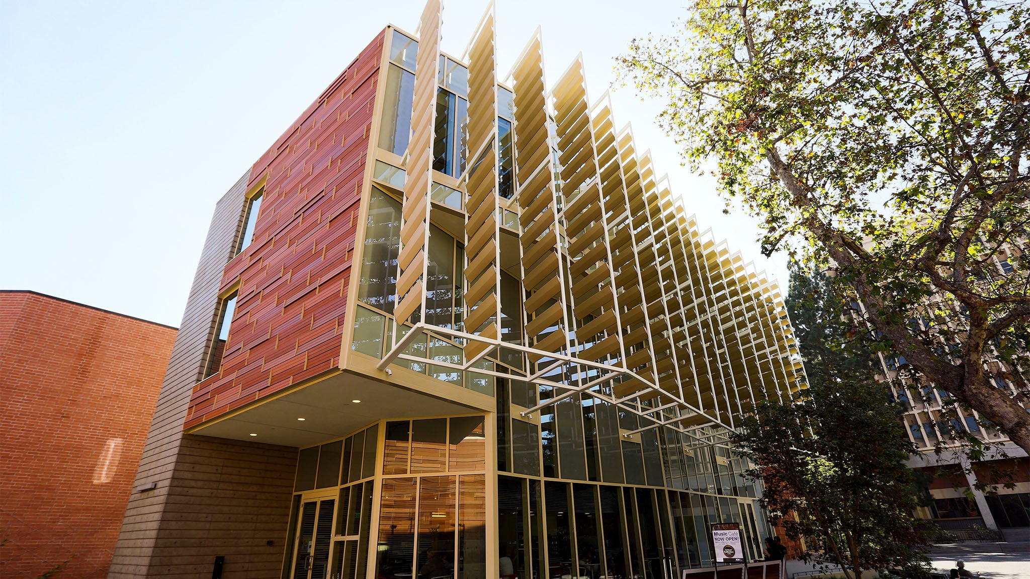 The Evelyn and Mo Ostin Music Center catches light and shadows from nearby trees.